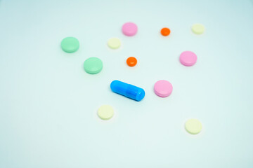 multicolored pills and capsules on a white background. medicine and self-medication. set of pills for treatment