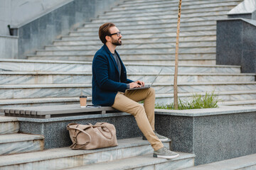 handsome busy bearded man working in park