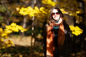 Fototapeta na wymiar Young woman in sunglasses in autumn forest
