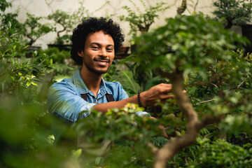 portrait of man taking care of plants in the garden