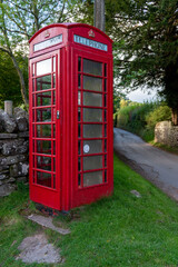 english red telephone box in countryside 