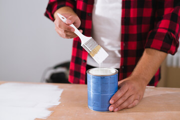 close up man painting with white paint