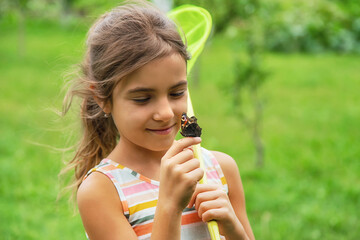 The child catches butterflies in nature. Selective focus. ,