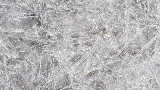 cracked ice texture on the surface, slow motion close-up, natural clean background. Frozen water texture