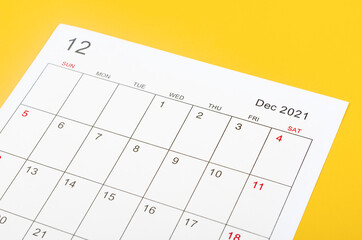 December 2021 calendar sheet on yellow background.