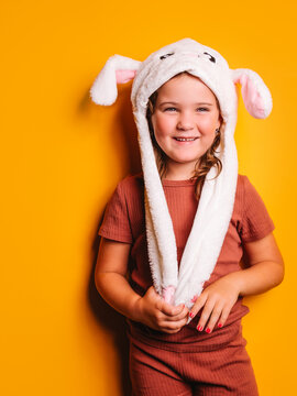 Delight girl in hat with bunny ears looking away