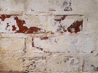 Old brick wall with peeling plaster, grunge texture