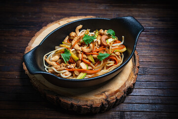 Asian style- restaurant background. Udon noodles with beef Wok
