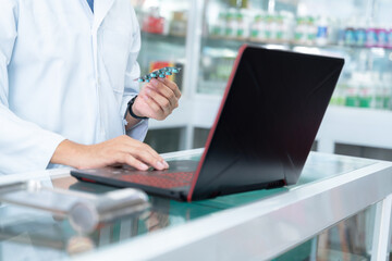 close up hand of pharmacist working at pharmacy. Medical healthcare concept.