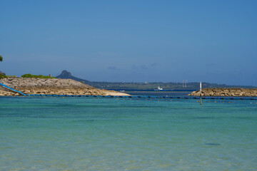 The view of Ie island and boat from a beach.