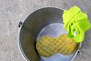 A clean sponge with fabric in a bucket ready to wash