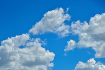 Naklejka na ściany i meble Beautiful white clouds on blue sky background.