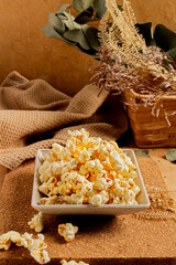 Cozy and aesthetic beige composition with popcorn. Autumn, winter food concept.