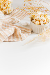 Cozy and aesthetic beige composition with popcorn. Autumn, winter food concept.