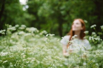 Young Woman smiling arms raised up, enjoy nature, celebrating freedom on green. Positive emotions....