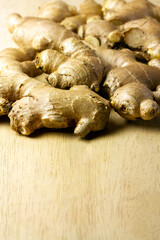 Fresh ginger on rustic wooden background. Ginger is a food and herb for healthcare.