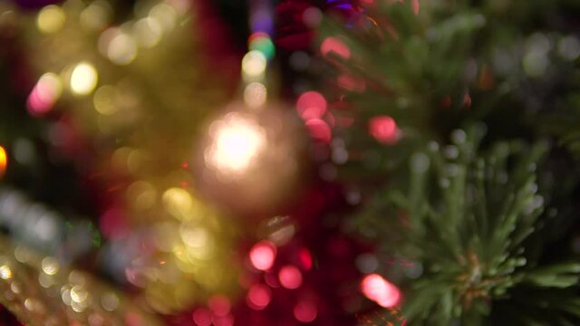 Blurred image and then focusing on the Christmas tree ball.Blurred background of a Christmas tree.
