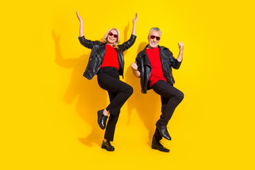Fototapeta na wymiar Full length body size view of beautiful handsome pensioner friends dancing fooling isolated over bright yellow color background