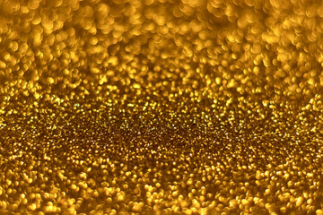 Gold sparkling glitter bokeh background, christmas abstract defocused texture. Holiday lights