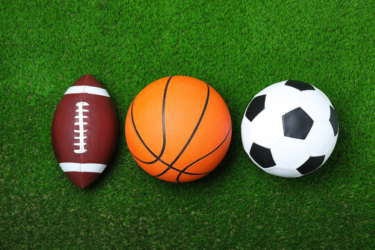Set of different sport balls on green grass, flat lay © New Africa