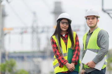 Two engineer working at power plant,Work together happily,Help each other analyze the problem,Consult about development guidelines