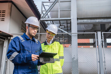 Engineers work place to keep liquid helium,preventive maintenance schedule checking,Thailand people,Technicians and engineers discuss work together.