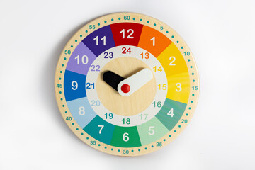 Colorful wooden clock toy isolated on white background . Studying of time by the child. 