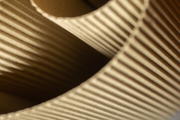 Rolled up corrugated cardboard cropped in slightly oblique angle photographed with bokeh in...