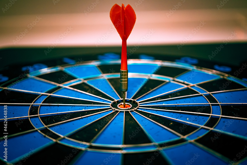 Poster close up shot of the dart arrow hit on bulleyes of dartboard to represent that the business reached 