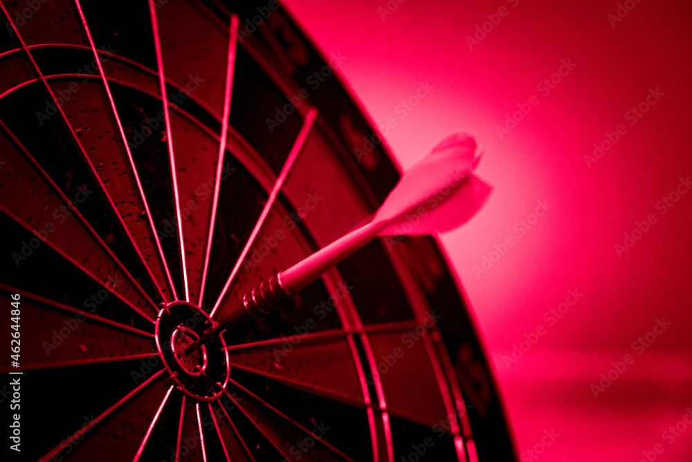 Poster close up shot of the dart arrow hit on bulleyes of dartboard to represent that the business reached 