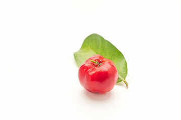 Ripe red acerola cherry fruit and green leaves isolated on white background. High vitamin C and antioxidant fruits. Top view. Space for text. Concept of healthy fruits