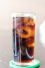 Refreshing Bubbly Soda Pop with Ice Cubes. Cold soda iced drink in a glasses - Selective focus,...