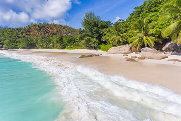 A view from a low hanging drone on the waves on Georgette beach of Praslin island, Seychelles