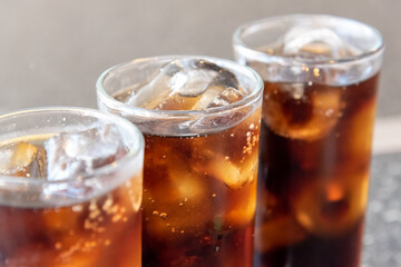 Refreshing Bubbly Soda Pop with Ice Cubes. Cold soda iced drink in a glasses - Selective focus,...