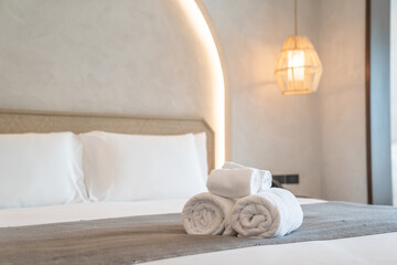 White towels on bed decoration in stylish bedroom interior