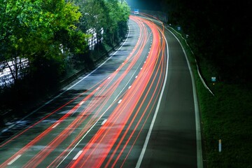 A freeway at night with the lighttrails of cars passing by