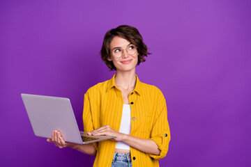 Portrait of attractive dreamy minded cheery girl holding using laptop startup isolated over bright...