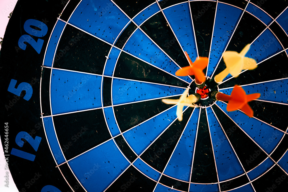 Poster close up shot of the dart arrow hit on bulleyes of dartboard to represent that the business reached 