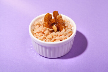 front view of tuna snack with walnut with purple background and copy space