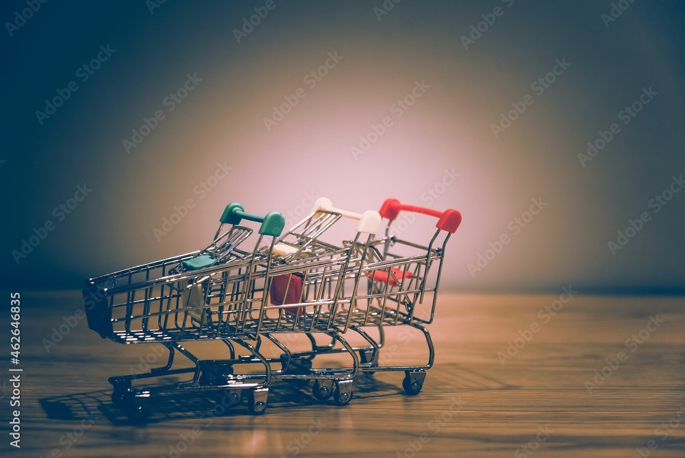 Poster close-up of shopping cart and on vintage retro background with some copy space for texting.