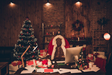 Photo of santa claus workplace christmas tree desk clothes xmas eve holly indoors inside home apartment