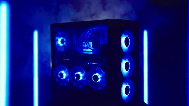 Cyber gamer computer with blue LED lights surrounded with neon lights and smoke 4K