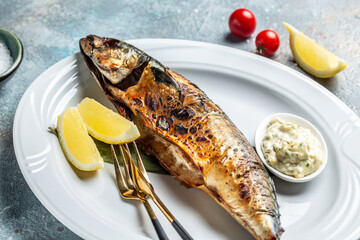 Scomber roast, baked mackerel fish with lemon and sauce. Japan dish, top view
