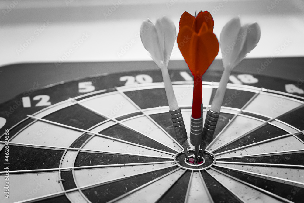 Aufkleber close up shot of the dart arrow hit on bulleyes of dartboard to represent that the business reached 