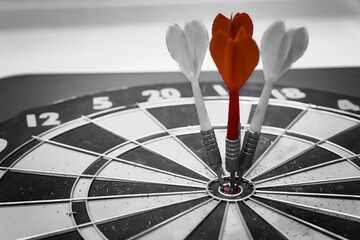 Close up shot of the dart arrow hit on bulleyes of dartboard to represent that the business reached...