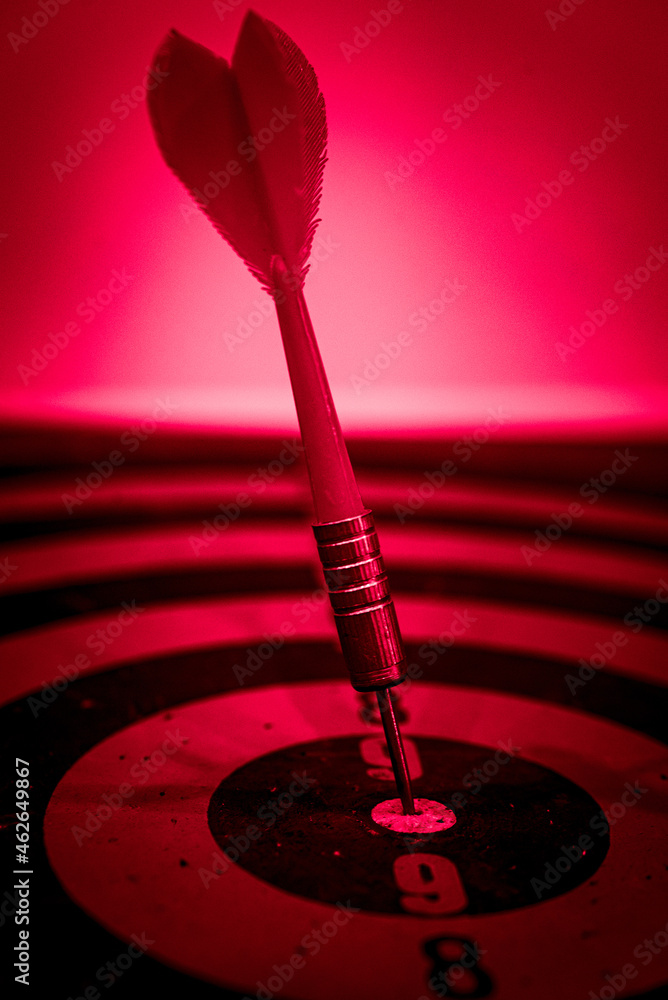 Poster close up shot of the dart arrow hit on bulleyes of dartboard to represent that the business reached 
