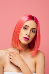 young woman with bright colorful hair and makeup isolated on pink