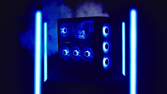 Blast of smoke hit RGB gaming personal computer surrounded with neon lights 4K