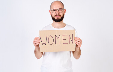 Mature handsome man holding a placard with the word woman in his hands.