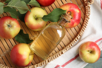 Natural apple vinegar and fresh fruits on table, flat lay
